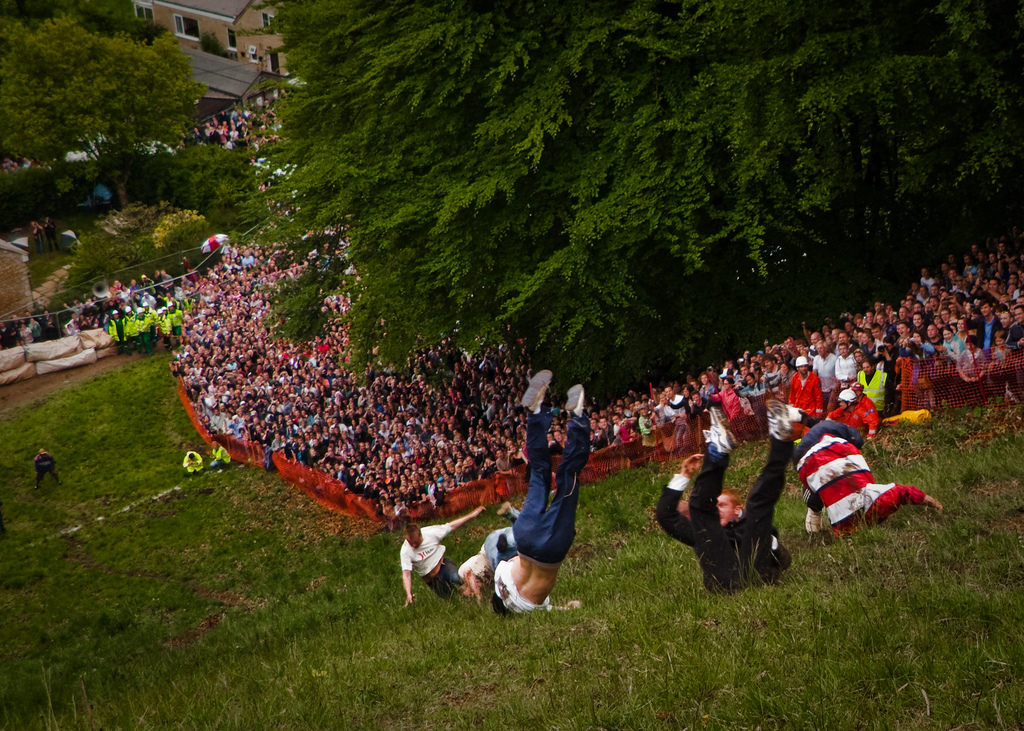 gGoucestershire cheese rolling festival contestants rolling down hill