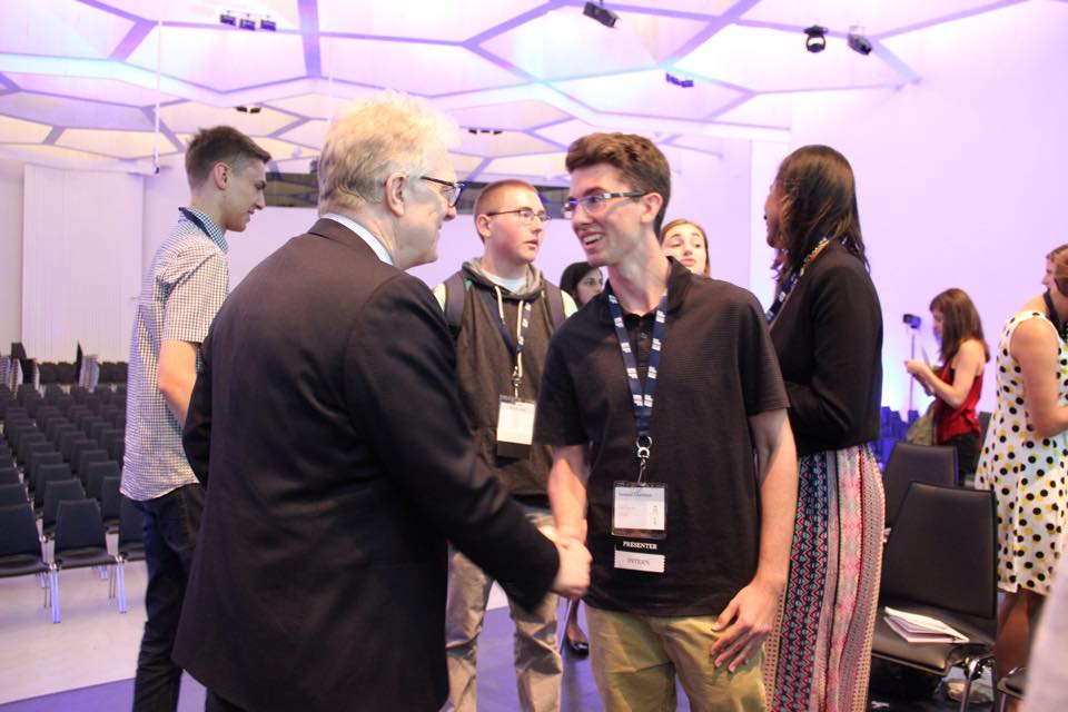 Sam shaking hands before starting a non-profit organization