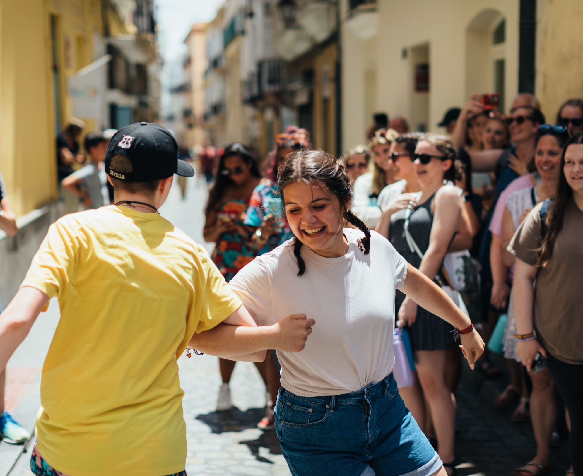 Two student travelers dancing in Spain. Sights like these are what help Spanish teachers rediscover their passion for teaching the language and culture.