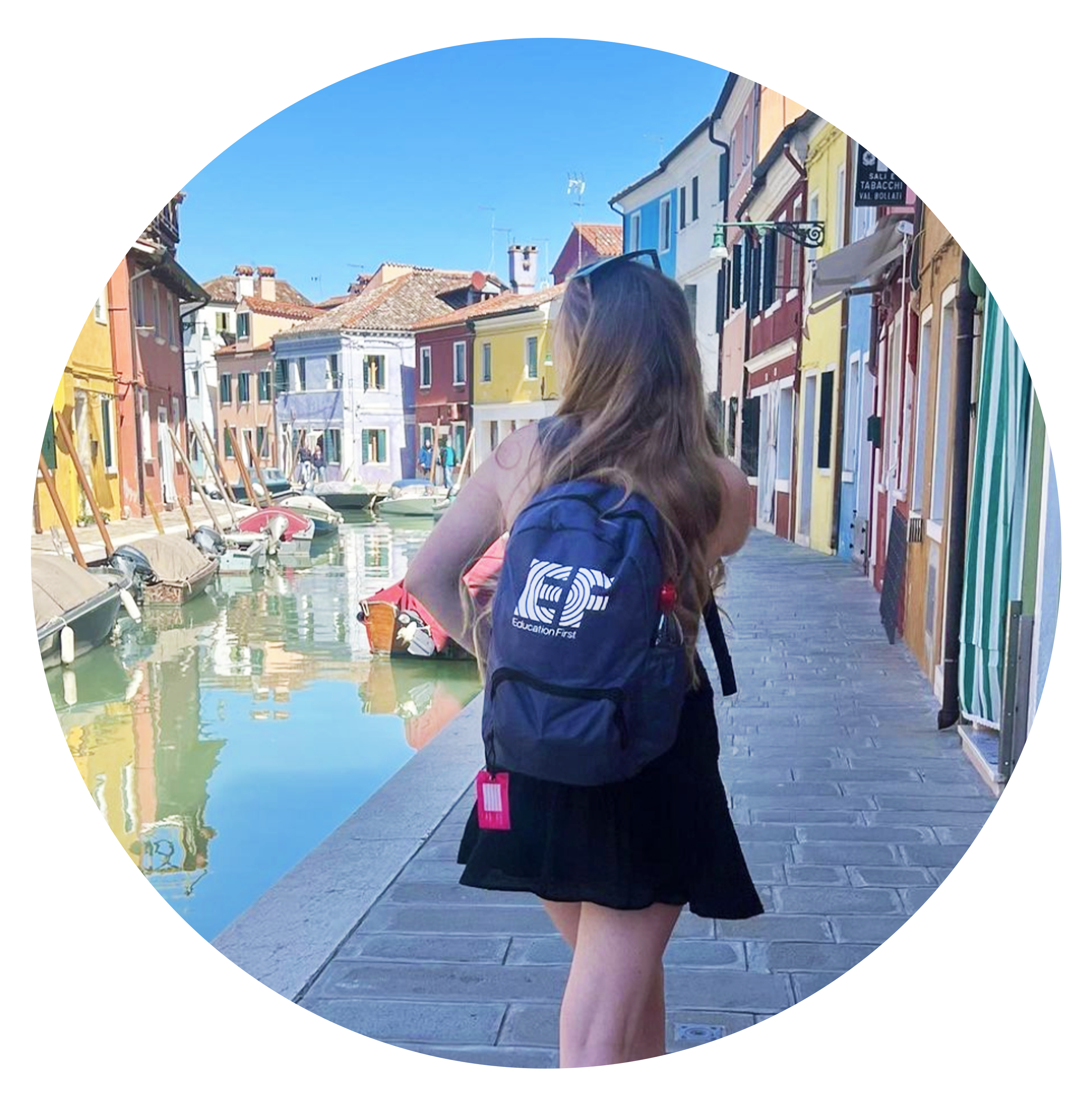 An EF traveler wears EF's new sustainable travel bag in Italy