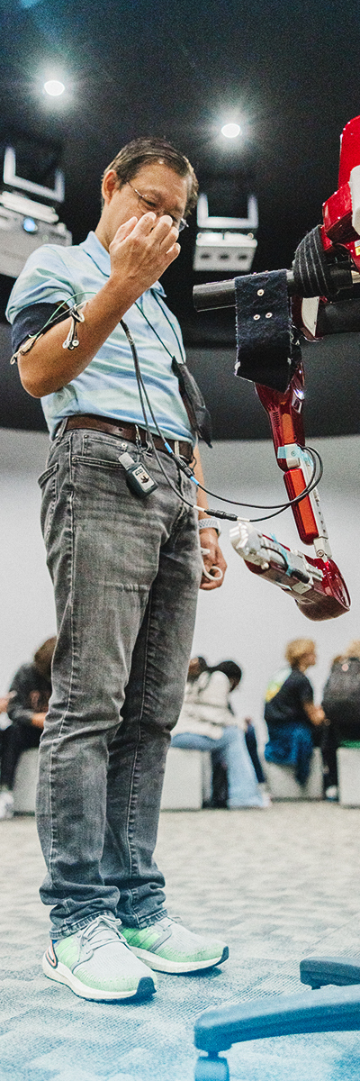 A man experimenting with the STEM innovation of a cybernetic robot arm